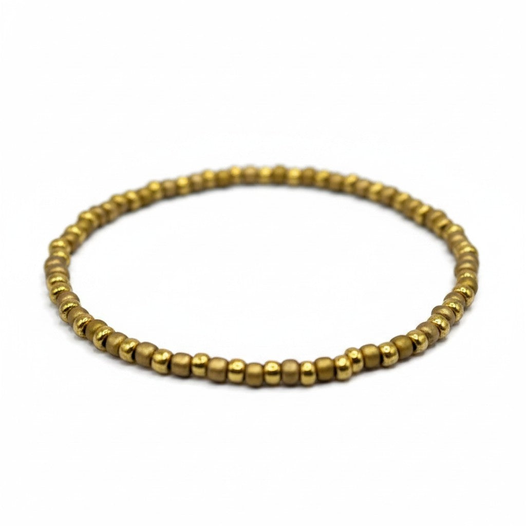 Handmade by Erika Liesel Golden Sand stretch bracelet featuring 3mm matte gold glass beads on a durable elastic cord.