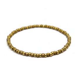 Handmade by Erika Liesel Golden Sand stretch bracelet featuring 3mm matte gold glass beads on a durable elastic cord.