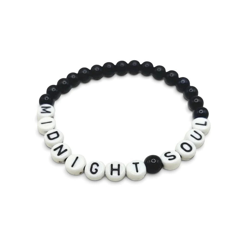 Handmade by Erika Liesel Midnight Soul stretch bracelet with glossy midnight-blue glass beads and lettered charms.