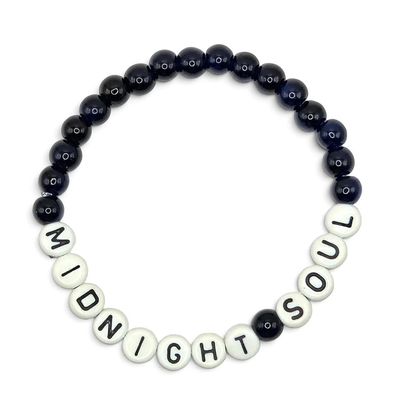 Handmade by Erika Liesel Midnight Soul stretch bracelet with glossy midnight-blue glass beads and white letter beads.