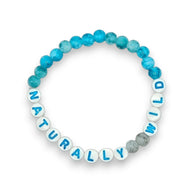 Handmade by Erika Liesel Naturally Wild stretch bracelet with blue marbled glass beads and white lettered charms.