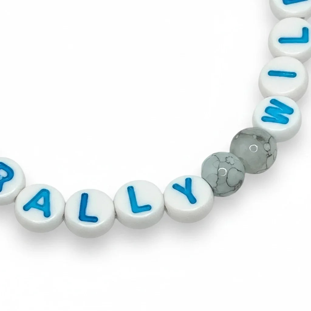 Handmade by Erika Liesel Naturally Wild stretch bracelet with white letter beads, blue text, and marbled grey beads.