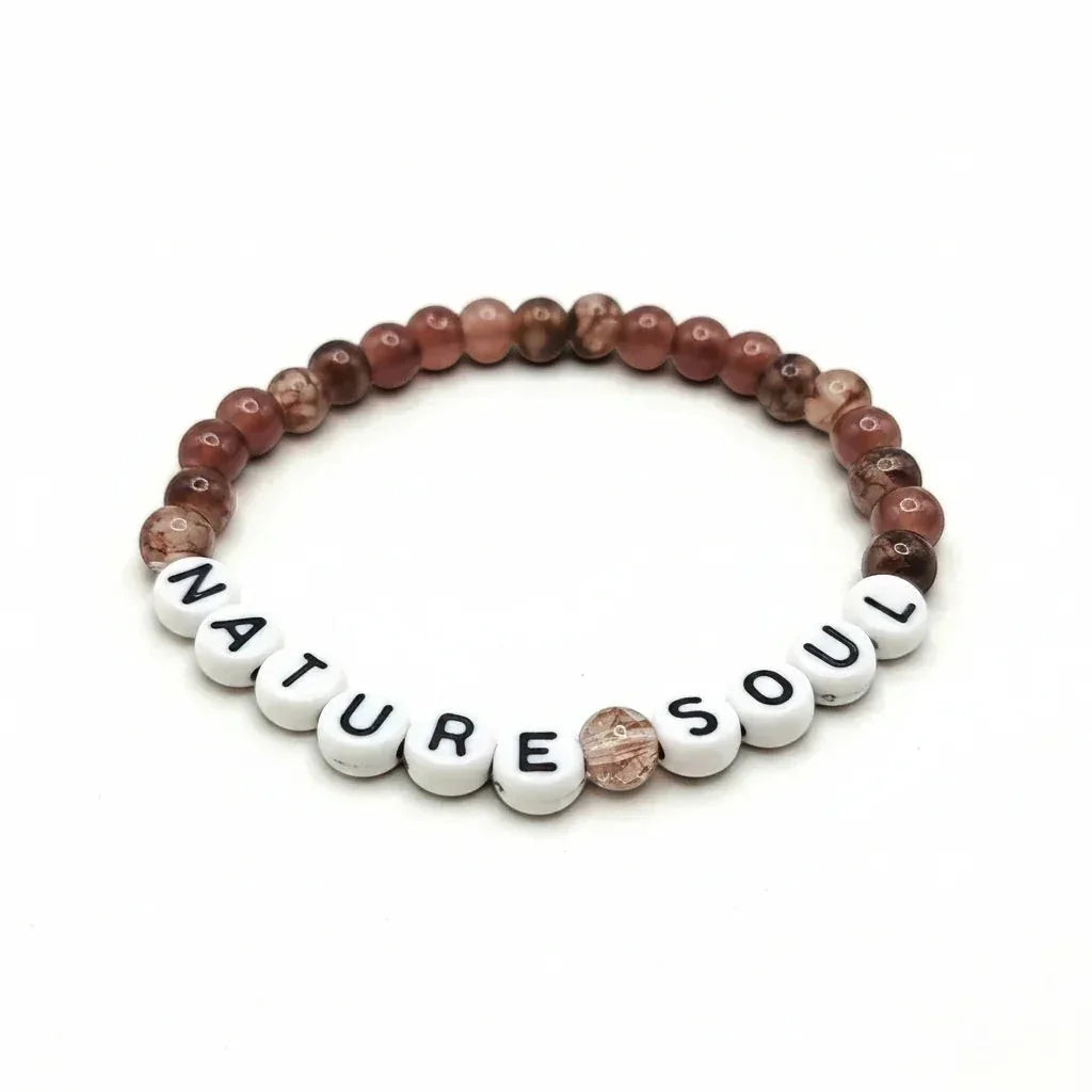 Handmade by Erika Liesel Nature Soul stretch bracelet with mauve and brown marbled glass beads on white letter beads.