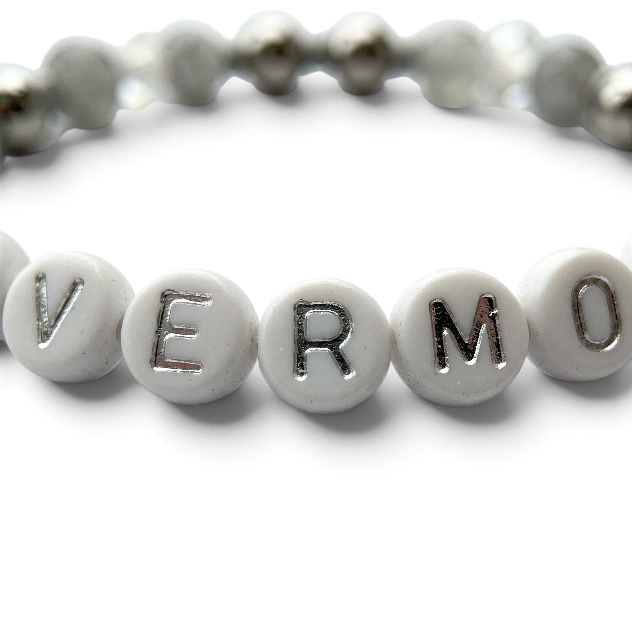 Handmade by Erika Liesel Nevermore stretch bracelet with white letter beads, gray marbled glass, and silver accents.