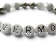Handmade by Erika Liesel Nevermore stretch bracelet with white letter beads, gray marbled glass, and silver accents.