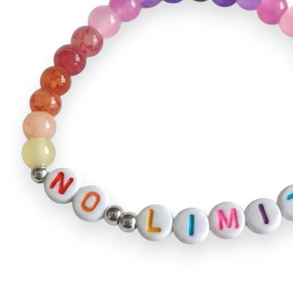 Handmade by Erika Liesel No Limits stretch bracelet with colorful glass beads and white lettered beads on white