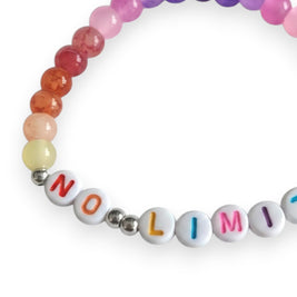 Handmade by Erika Liesel No Limits stretch bracelet with colorful glass beads and white lettered beads on white