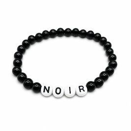 Handmade by Erika Liesel Noir bracelet featuring black glass beads and white letter beads on a stretch cord