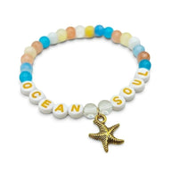 Handmade by Erika Liesel Ocean Soul stretch bracelet with colorful glass beads and a gold-tone starfish charm.