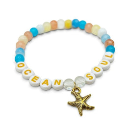 Handmade by Erika Liesel Ocean Soul stretch bracelet with colorful glass beads and a gold-tone starfish charm.