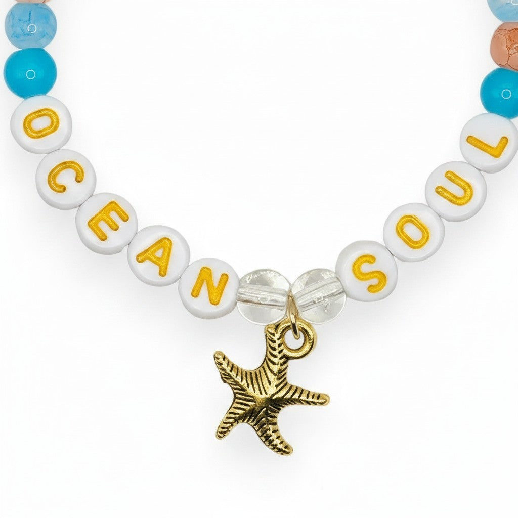 Handmade by Erika Liesel Ocean Soul stretch bracelet with colorful glass beads and a gold-tone starfish charm.