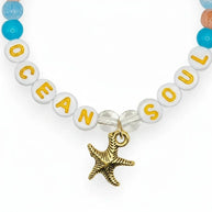 Handmade by Erika Liesel Ocean Soul stretch bracelet with colorful glass beads and a gold-tone starfish charm.