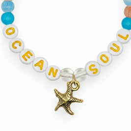 Handmade by Erika Liesel Ocean Soul stretch bracelet with colorful glass beads and a gold-tone starfish charm.