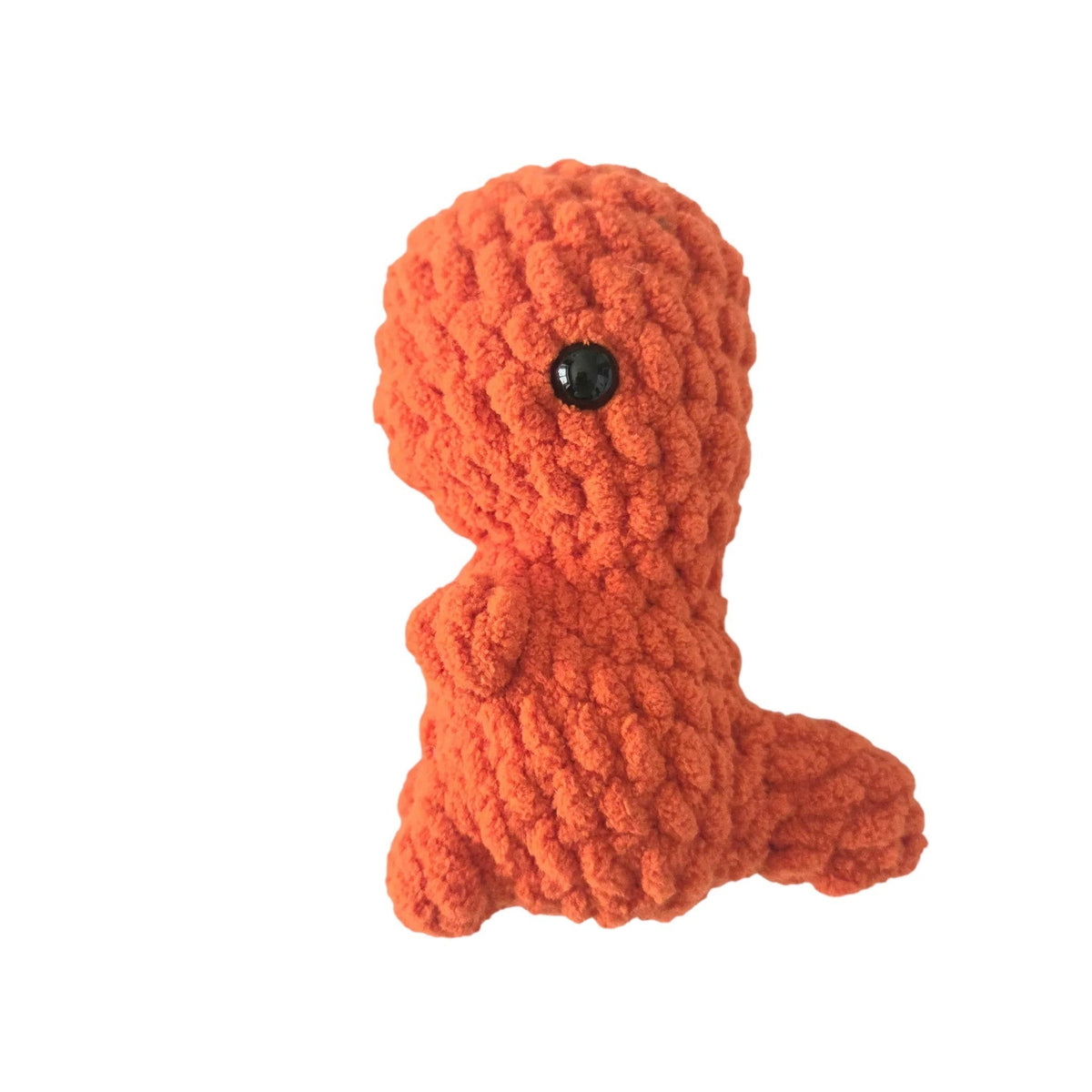 Handmade by Erika Liesel orange crochet dinosaur plushie made from soft chenille yarn with black safety eyes.