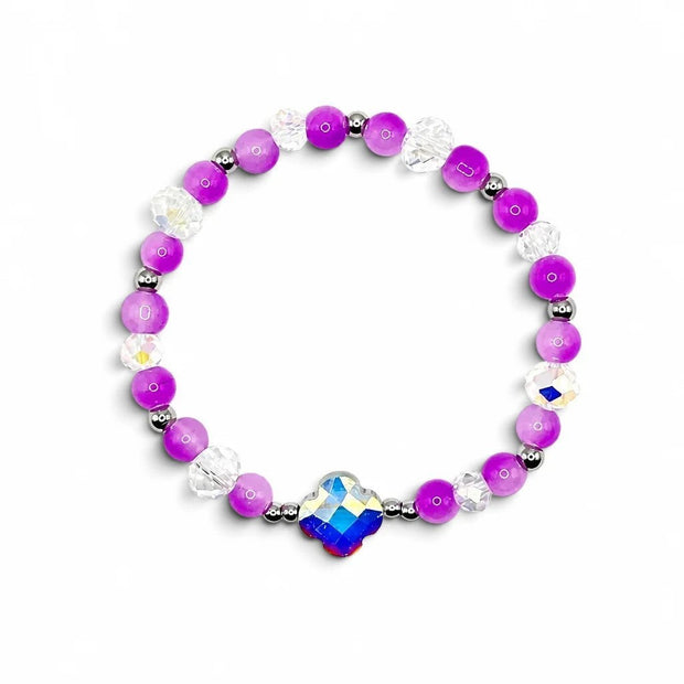 Handmade by Erika Liesel orchid bracelet with vibrant purple glass beads, clear crystals, and iridescent centerpiece.