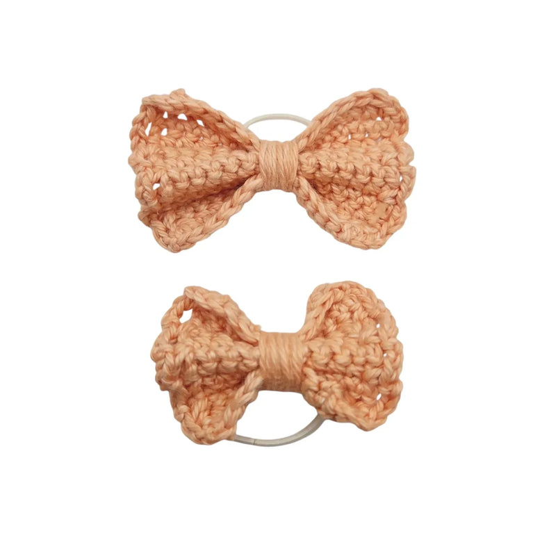 Handmade by Erika Liesel peach crochet bow hair tie set featuring two different sized textured yarn bows