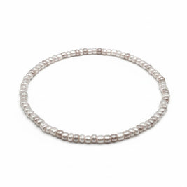 Handmade by Erika Liesel pearl gray stretch bracelet featuring delicate 3mm glass beads with a luminous finish.