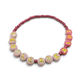 Handmade by Erika Liesel People Are A Lot bracelet with pink glass beads and gold letter beads on a stretch cord.
