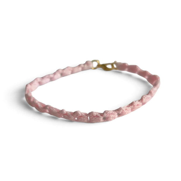 Delicate pink crocheted bracelet with gold clasp, handmade for cozy everyday wear