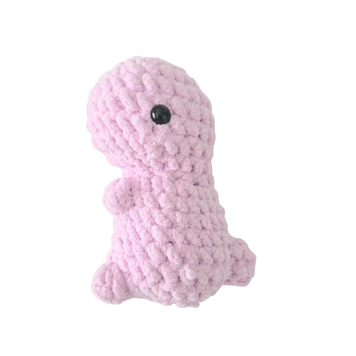 Handmade by Erika Liesel light pink crochet dinosaur plushie made from soft chenille yarn with a black safety eye.