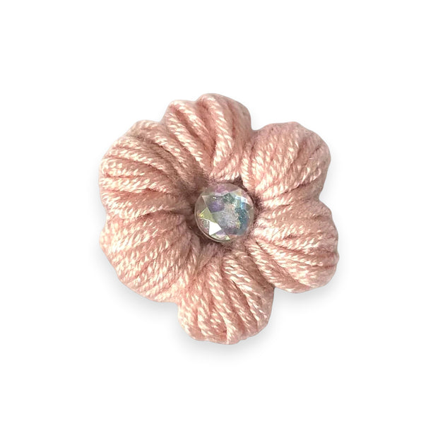 Handmade pink crochet flower pin with iridescent gem center, cozy craft gift