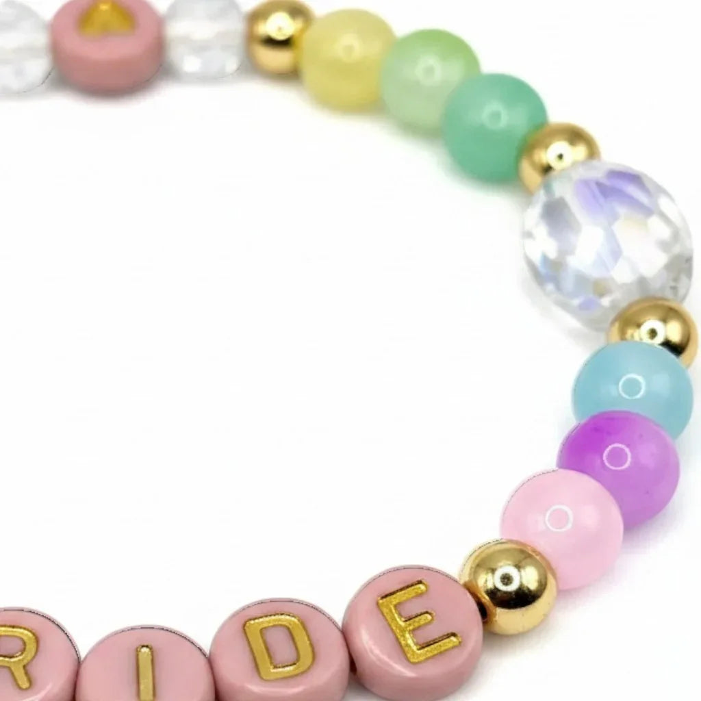 Handmade by Erika Liesel Pride bracelet featuring colorful crystal glass beads and 18K gold-plated accent beads.