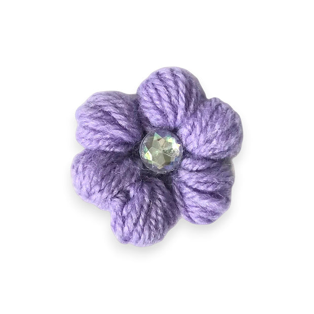 Handmade purple crochet flower with iridescent gem center, cozy craft gift