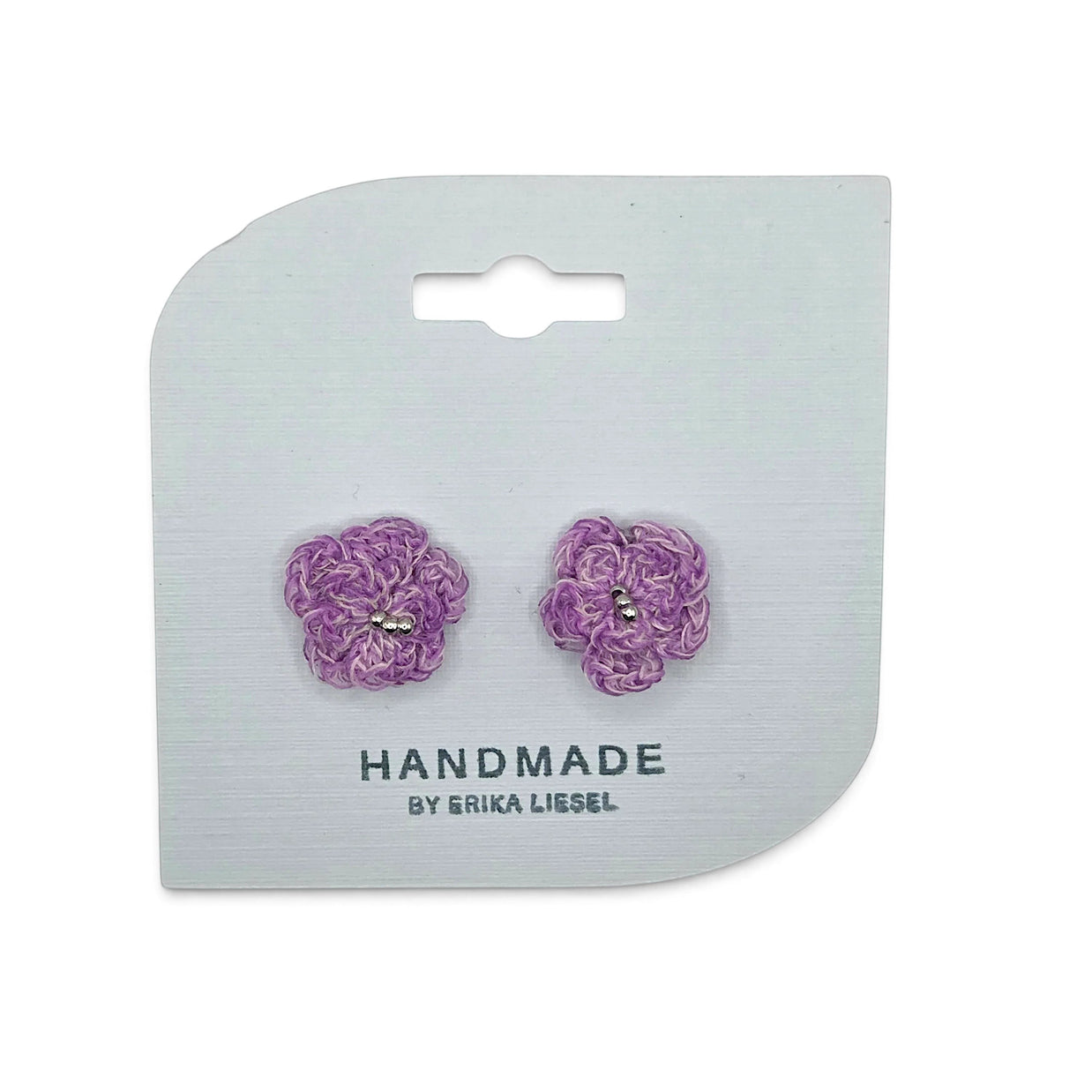 Handmade by Erika Liesel Bloom crochet flower earrings in purple with delicate bead accents on a display card.