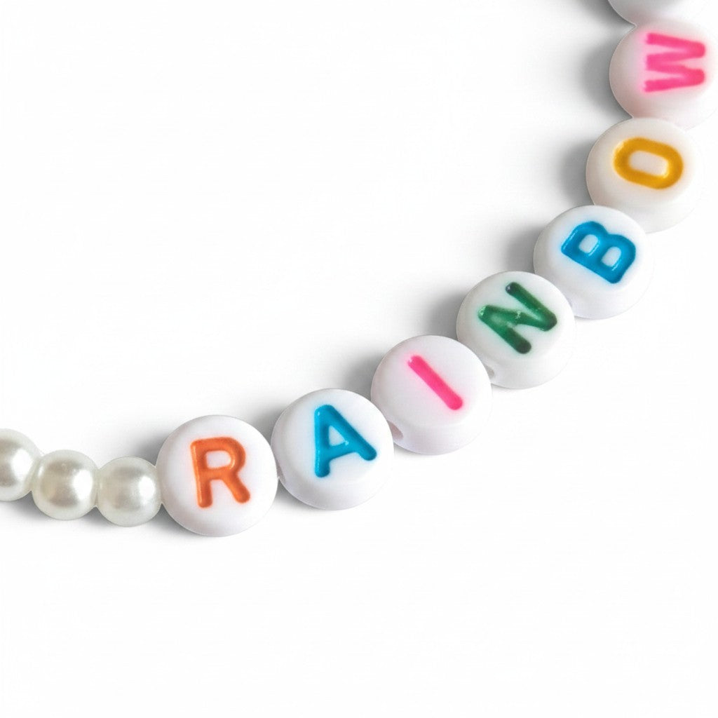 Handmade by Erika Liesel Chasing Rainbows elastic bracelet with colorful letter beads and white pearl accents