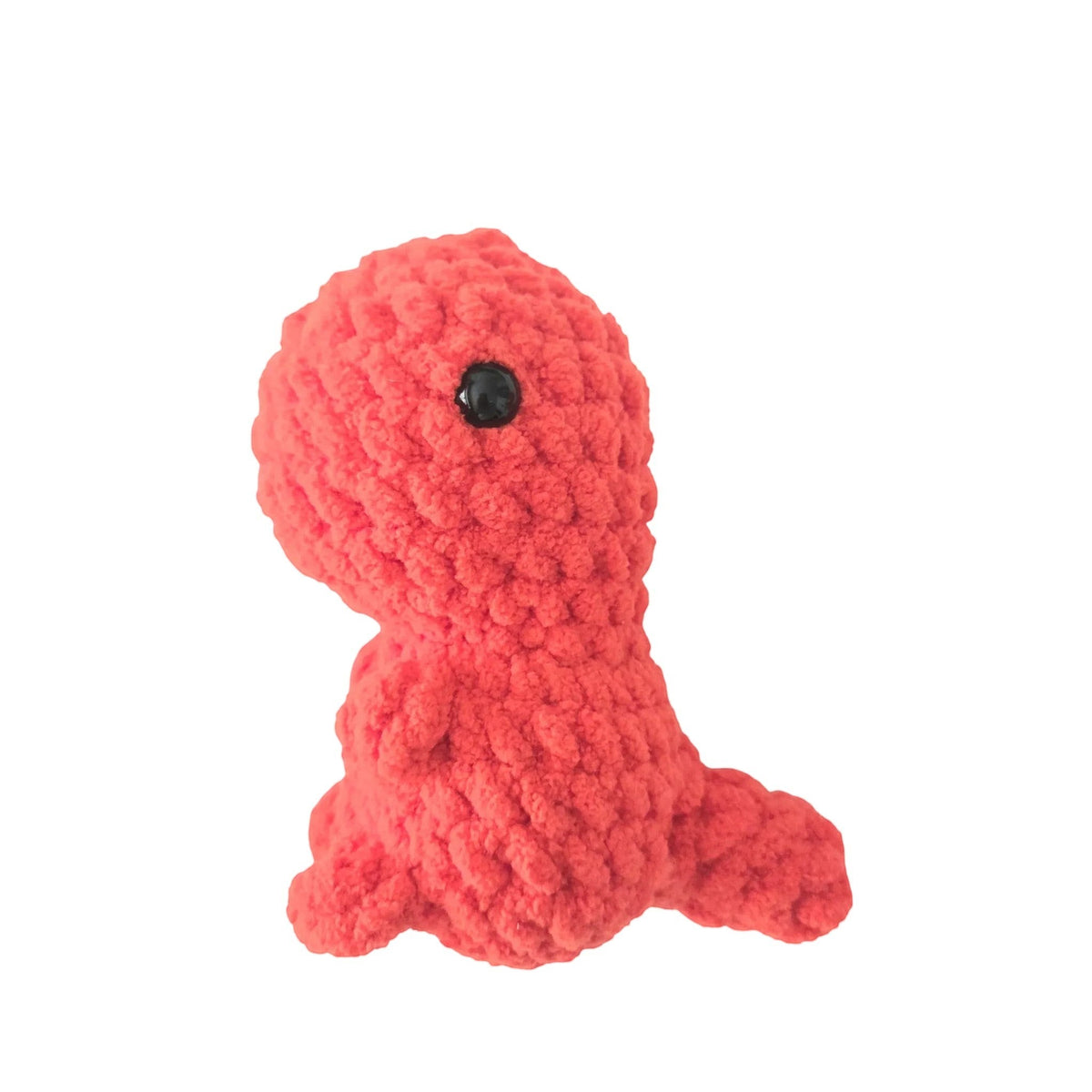Handmade by Erika Liesel red crochet dinosaur plushie made from soft chenille yarn with black safety eyes.
