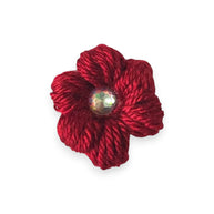 Handmade red crochet flower pin with sparkling gem center, cozy craft gift