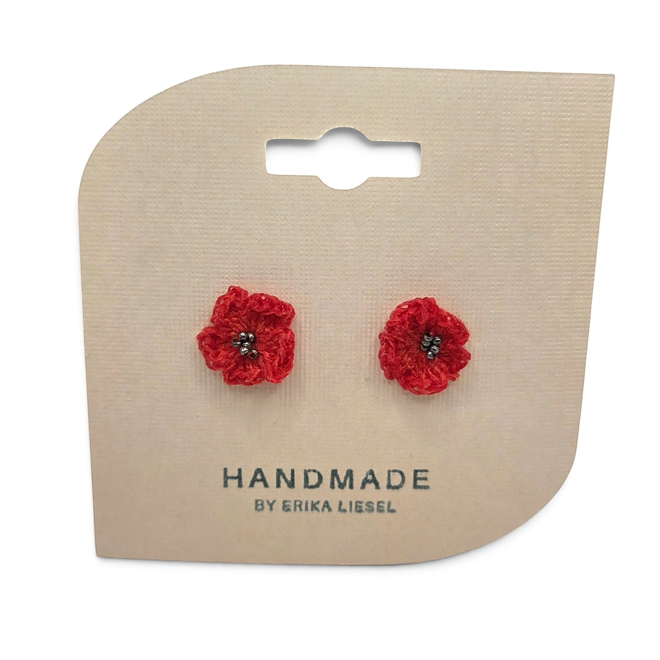 Handmade by Erika Liesel red crochet flower stud earrings with small bead centers on a branded display card.