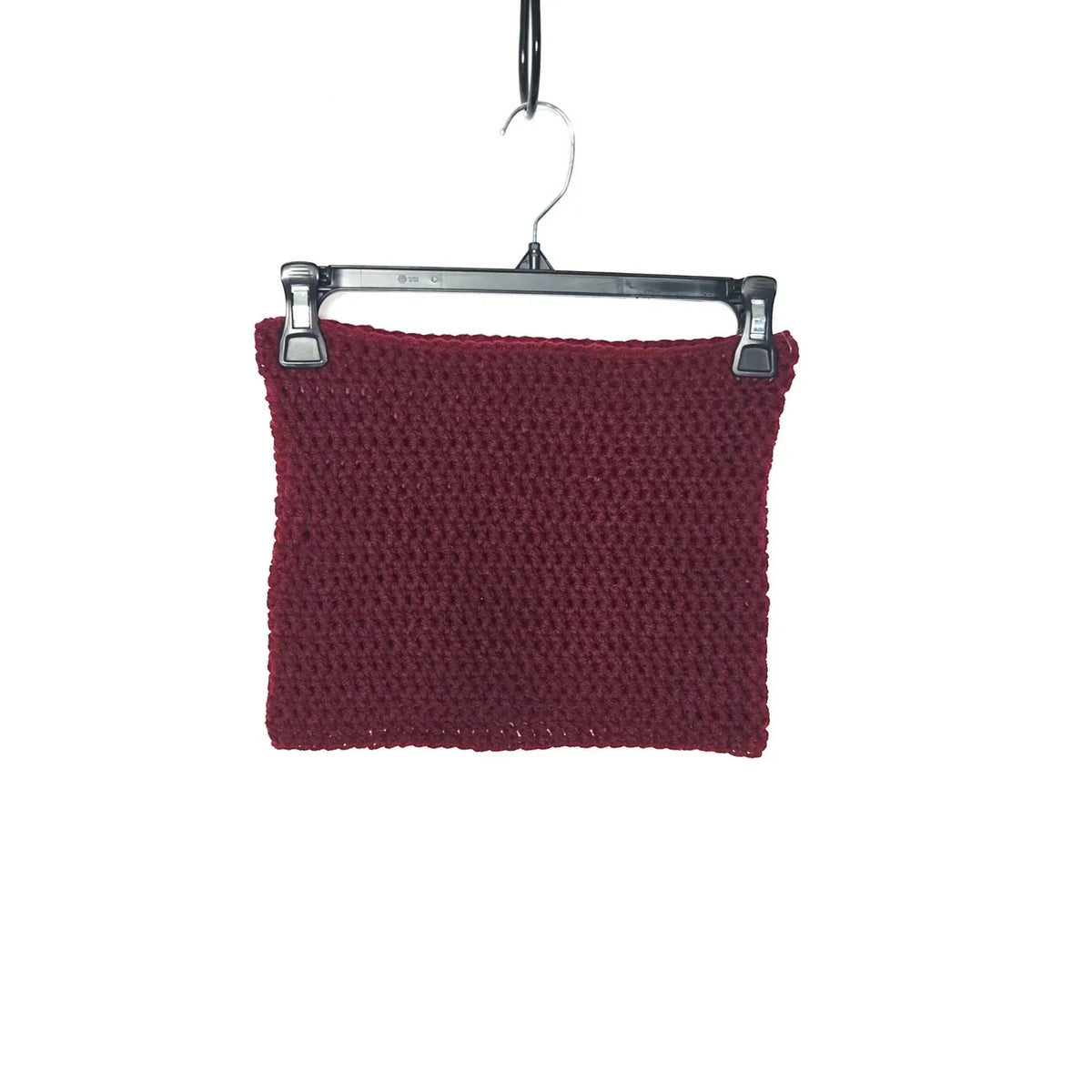 Handmade by Erika Liesel deep red crochet neck warmer hanging on a black plastic hanger against a white background.