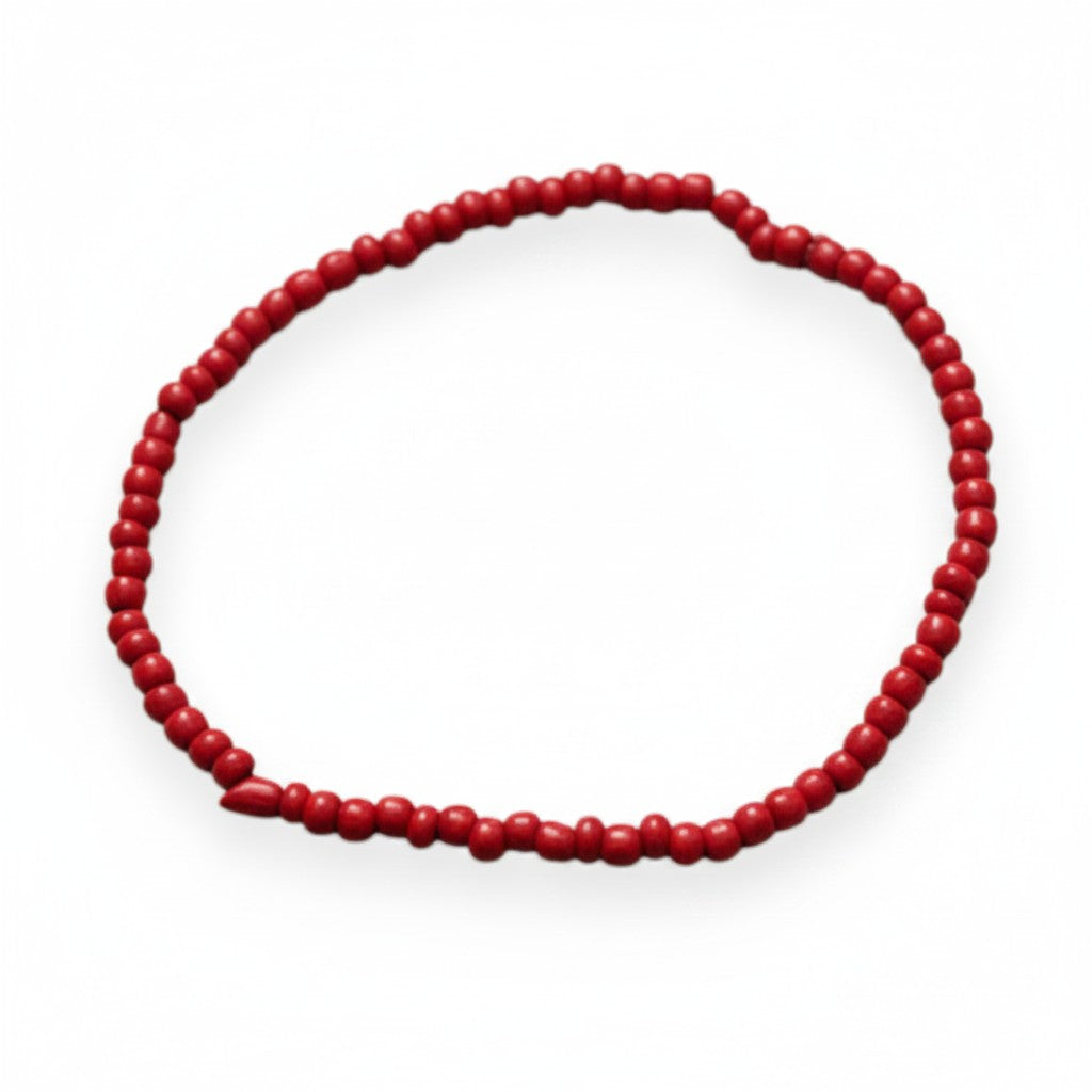Handmade by Erika Liesel red glass bead stretch bracelet with a polished finish and durable elastic cord.