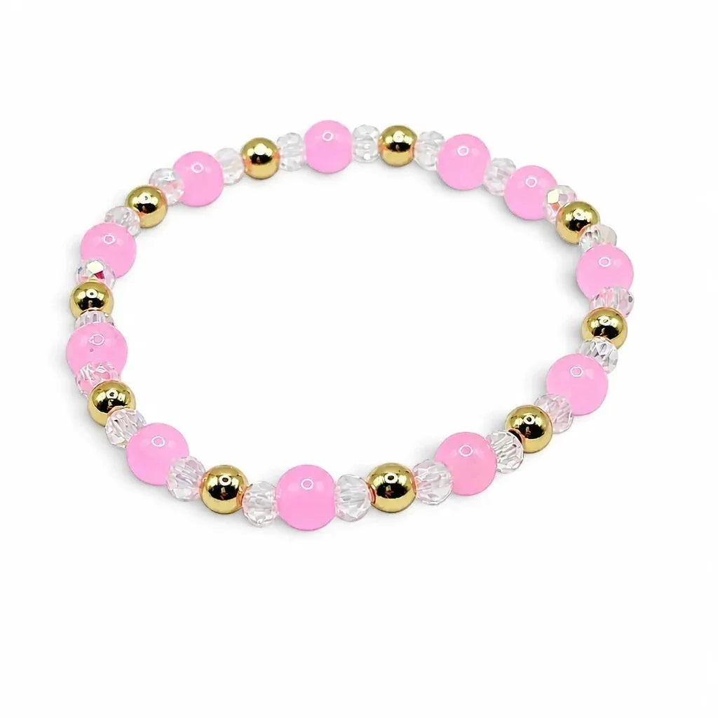 Handmade by Erika Liesel stretch bracelet featuring pink glass beads, clear crystal accents, and 18K gold-plated beads.