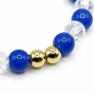 Handmade by Erika Liesel sapphire bracelet featuring cobalt blue glass beads, clear crystals, and 18K gold-plated accents