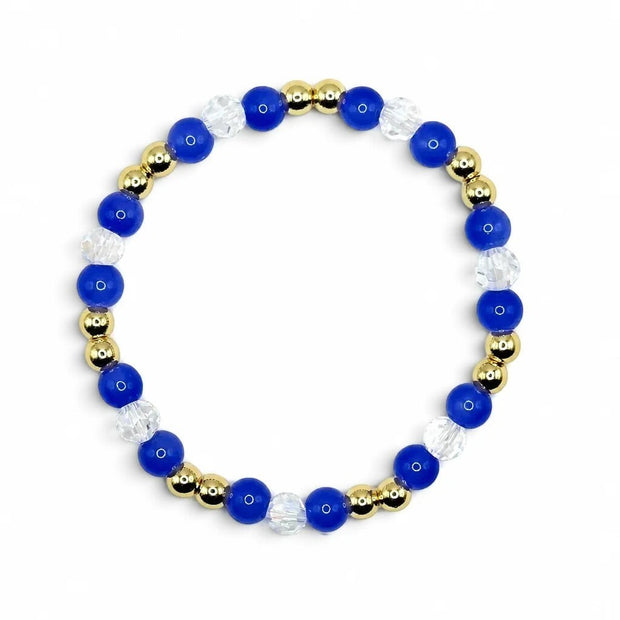 Handmade by Erika Liesel sapphire bracelet featuring cobalt blue glass beads, clear crystals, and 18K gold-plated accents.