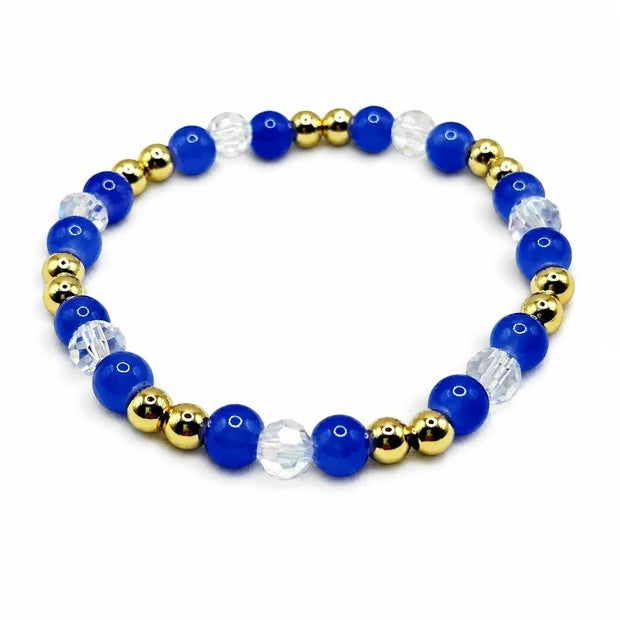 Handmade by Erika Liesel sapphire blue glass bead bracelet with clear crystal accents and 18K gold-plated beads.