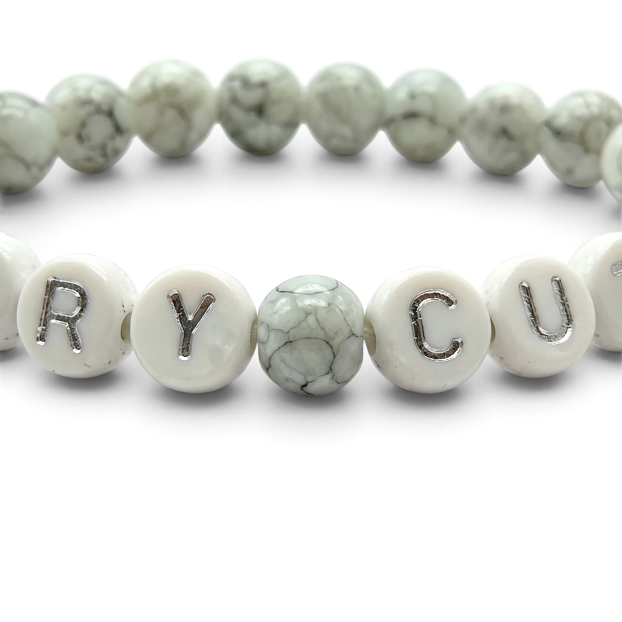 Handmade by Erika Liesel Scary Cute bracelet with gray marbled glass beads and white letter beads on elastic cord