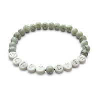 Handmade by Erika Liesel Scary Cute bracelet featuring gray marbled glass beads and silver lettered accent beads.