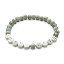 Handmade by Erika Liesel Scary Cute bracelet featuring gray marbled glass beads and silver lettered accent beads.