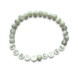 Handmade by Erika Liesel Scary Cute bracelet featuring marbled gray glass beads and silver lettered beads.