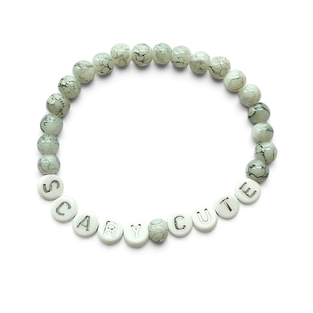 Handmade by Erika Liesel Scary Cute bracelet featuring marbled gray glass beads and silver lettered beads.