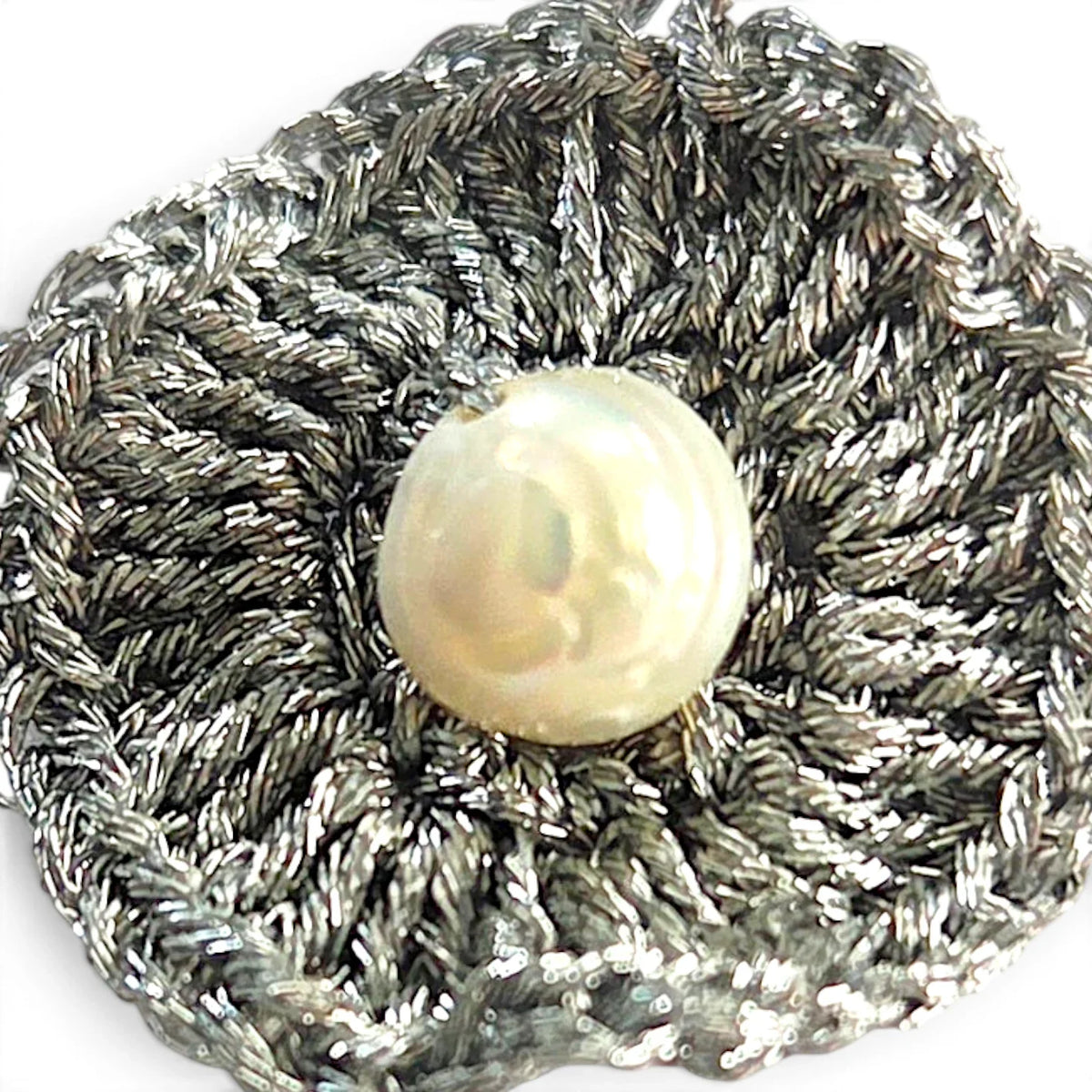 Handmade by Erika Liesel silver metallic crochet flower earring with a central genuine freshwater pearl drop.