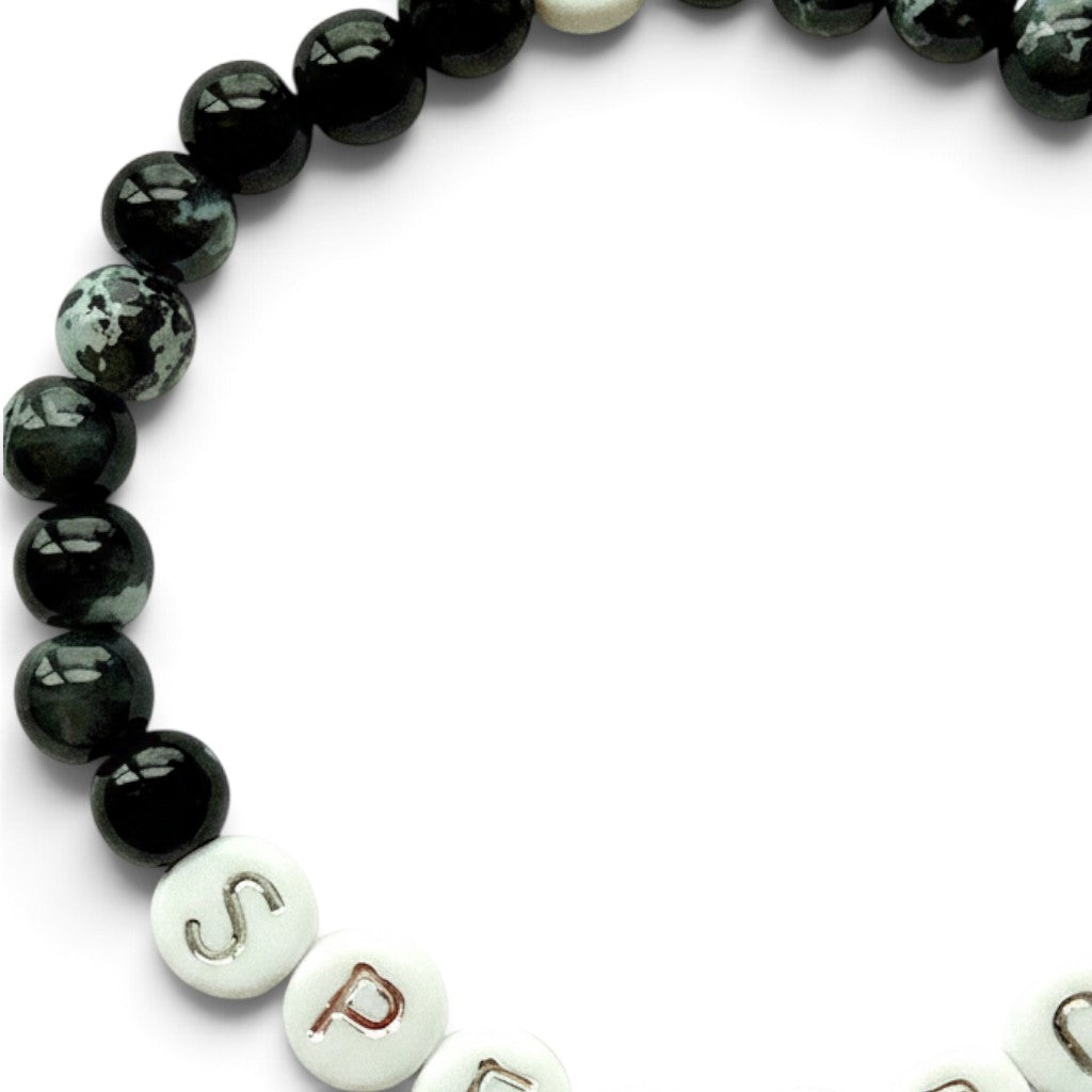 Handmade by Erika Liesel Spellbound stretch bracelet with glossy black glass beads and silver lettered beads