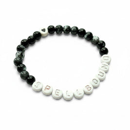 Handmade by Erika Liesel Spellbound stretch bracelet with black glass beads, silver letter beads, and a heart charm.