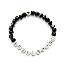 Handmade by Erika Liesel Spellbound stretch bracelet with glossy black glass beads and silver lettered beads.