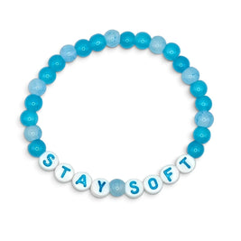 Handmade by Erika Liesel Stay Soft stretch bracelet featuring bright and pale blue glass beads with white letter beads.