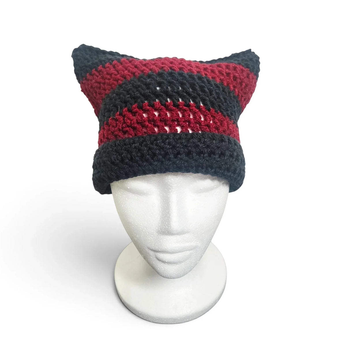 Handmade by Erika Liesel black and red striped crochet cat-ear beanie on a white mannequin head