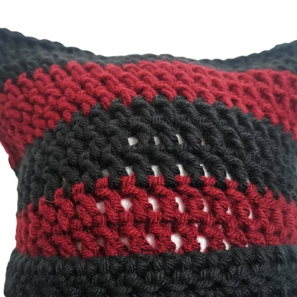 Handmade by Erika Liesel striped black and dark red crochet cat-ear beanie with a textured knit pattern.